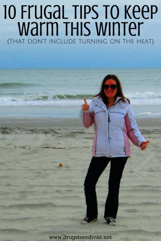 A woman in a coat on the beach with the words "10 Frugal Tips To Keep Warm This Winter (That don't include turning on the heat)" digitally written above her.
