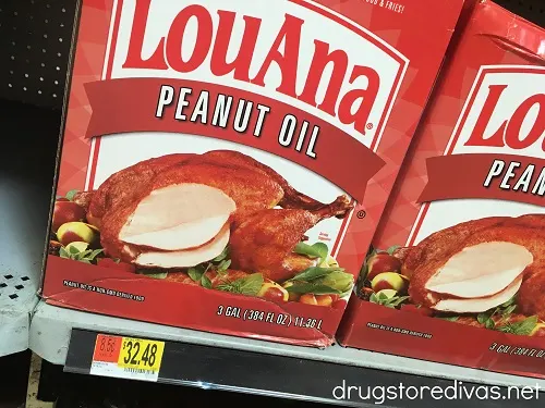 Two boxes of Lou Ana Peanut Oil on a shelf in a store.