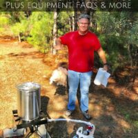 Man holding a turkey and paper towels in front of an outdoor fryer and propane tank with the words 