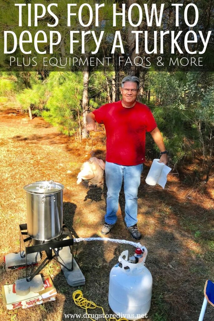 Man holding a turkey and paper towels in front of an outdoor fryer and propane tank with the words "Tips for how to deep fry a turkey plus equipment, FAQ's & more" digitally written on top.