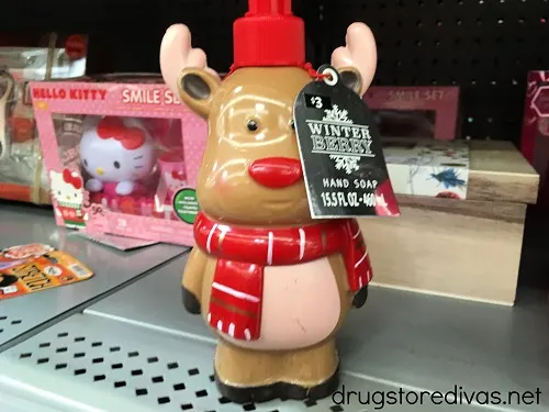 Rudolph the red nosed reindeer-shaped hand soap on a shelf.