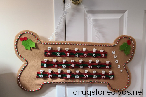 DIY Dog Treat Advent Calendar hanging on a door.