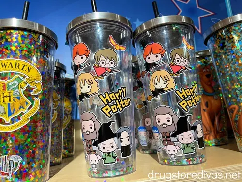 Three rows of Harry Potter-themed tumblers on a shelf.