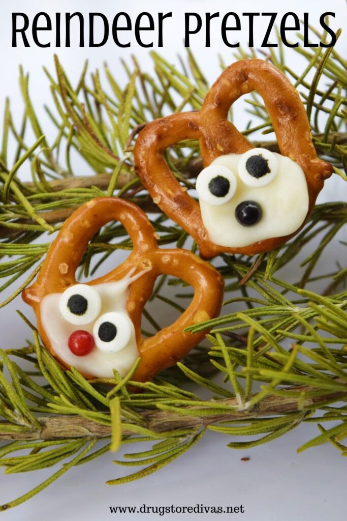 Two homemade reindeer-shaped pretzels on rosemary with the words "Reindeer Pretzels" digitally written on top.