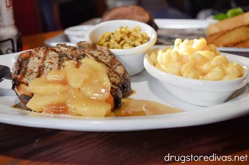 Pork porterhouse with caramel apples, corn, and macaroni and cheese.