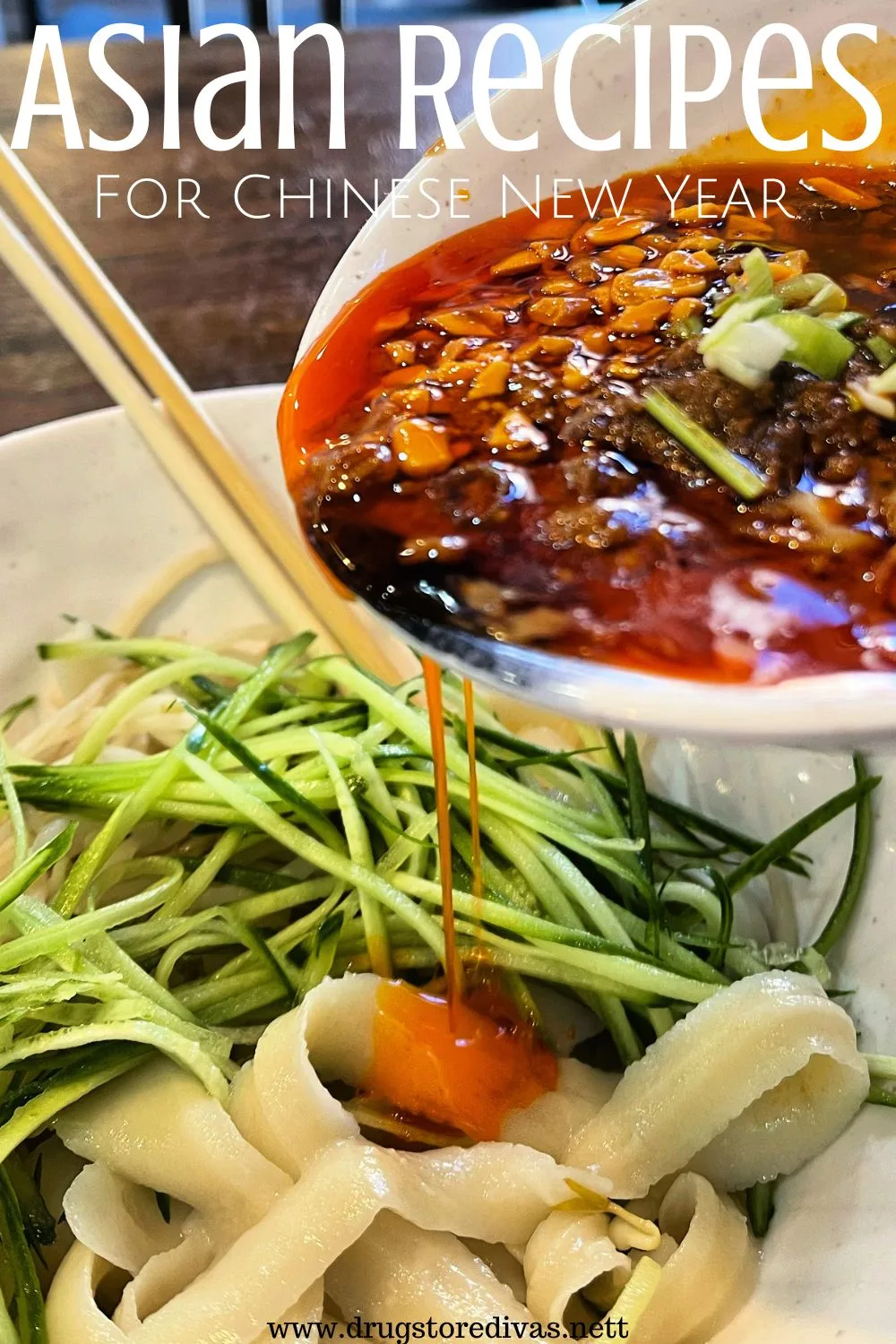 A bright red broth being poured from a white bowl onto noodles and sliced greens with the words 