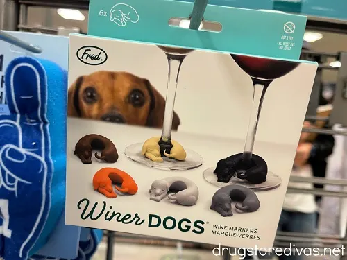 A box of winer dogs wine markers on a shelf.