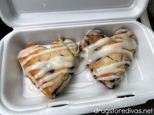 Two heart shaped biscuits with icing on them in a styrofoam container from Bojangles.