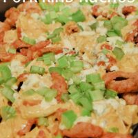 Buffalo Chicken Nachos in a pan with the words 