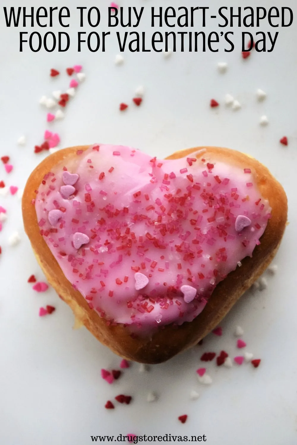 A heart doughnut surrounded by sprinkles with the words 