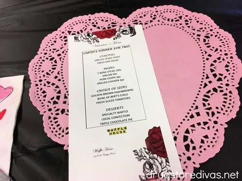 A pink heart doily with a Valentine's Day menu for Waffle House sitting on top.