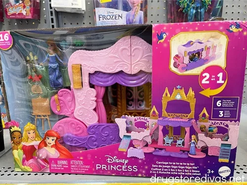 A Disney Princess Carriage to Castle Transforming Playset in a box on a shelf in a store.