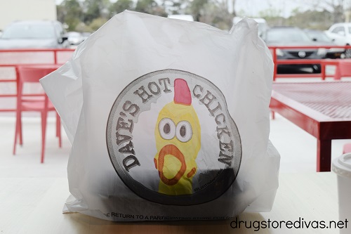 A to go bag on a table at Dave's Hot Chicken.