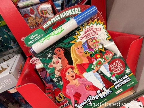 A Disney Princess Imagine Ink book on a shelf in a store.