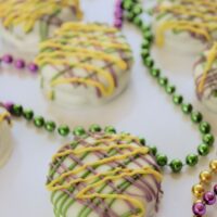Green, pink, and yellow Oreo cookies with beads on a tray and the words 