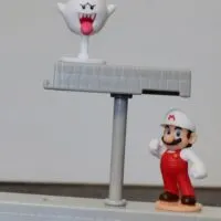 Super Mario and a ghost on a balancing game with the words 
