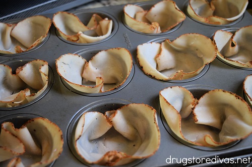 Turkey slices in the 12 cavities of a muffin pan.