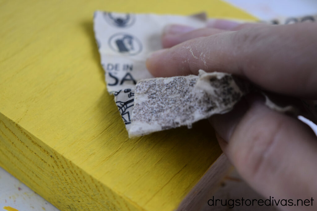 A yellow block being sanded.