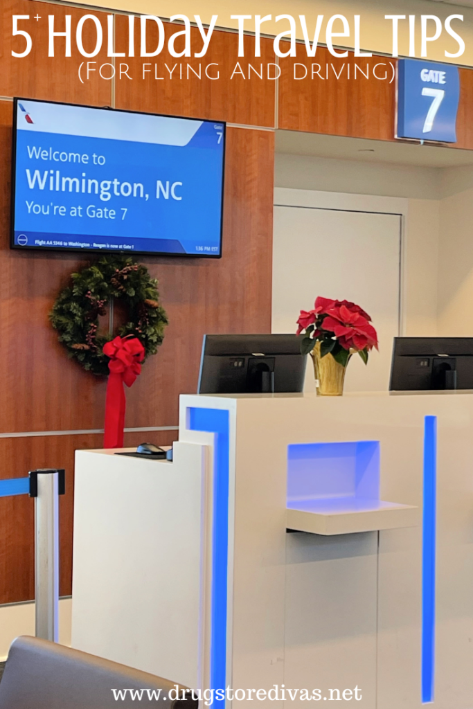 A ticketing center at an airport gate, with a poinsettia and wreath, and gate signs with the words "5+ Holiday Travel Tips for flying and driving" digitally written above it.