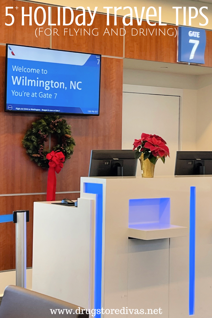 A ticketing center at an airport gate, with a poinsettia and wreath, and gate signs with the words 