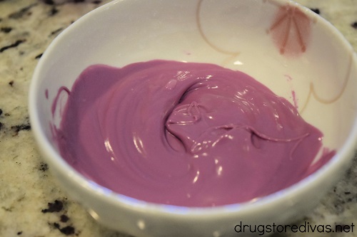 Purple candy melts melted in a bowl.