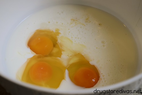 Eggs, milk, and honey in a bowl.