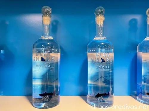 Bottles of Blue Shark vodka on a shelf in a store.