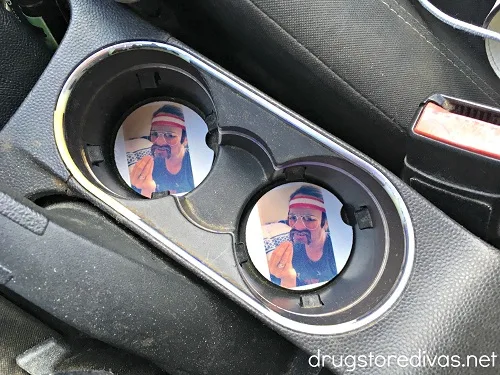 Two photo car coasters in a car.