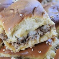Cheeseburger sliders piled on top of each other with the words 