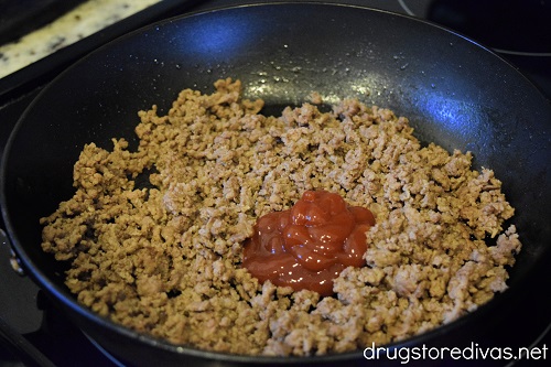 Ground beef and ketchup in a pan.