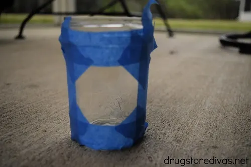 A mason jar with painter's tape around it.