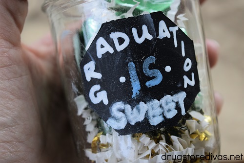 A mason jar with the words "Graduation Is Sweet" written on it.