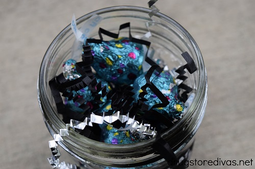 Candy and paper shred in a mason jar.
