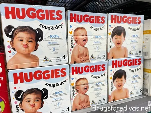 Boxes of Huggies diapers on a shelf in a store.