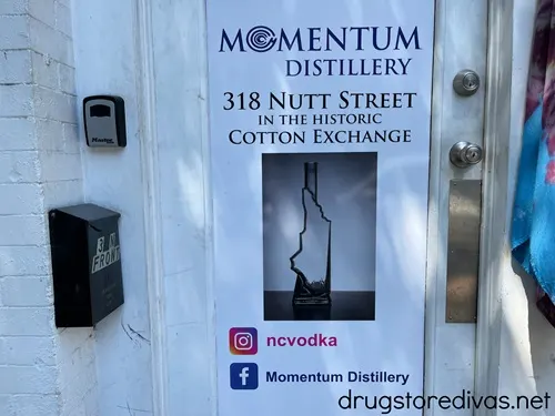 A sign advertising Momentum Distillery in Wilmington, NC.