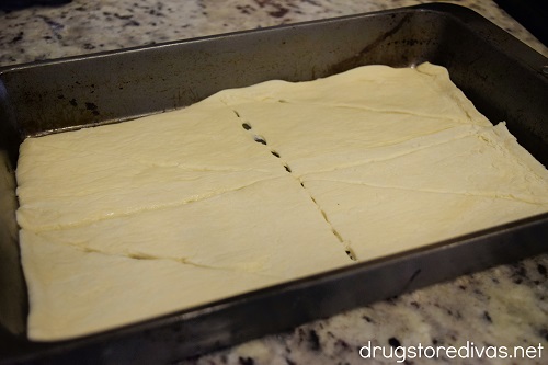 Crescent rolls in the bottom of a cake pan.