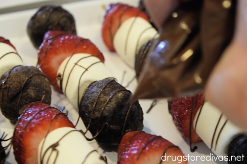 Chocolate being piped over Chocolate Strawberry Dessert Kabobs.