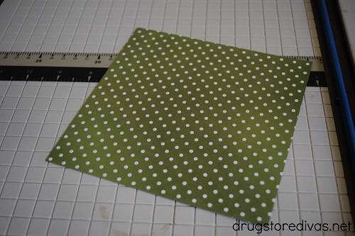 A square of scrapbook paper on a paper trimmer.