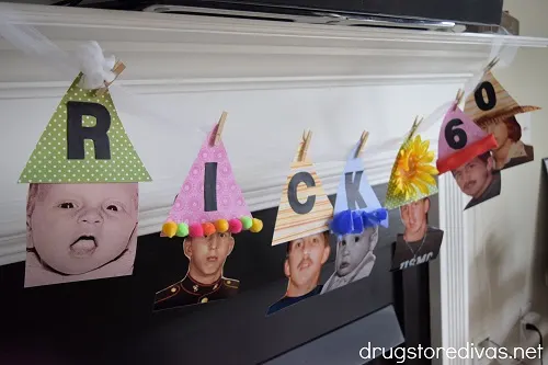 A DIY Birthday Party Hat Banner displayed on a fireplace.