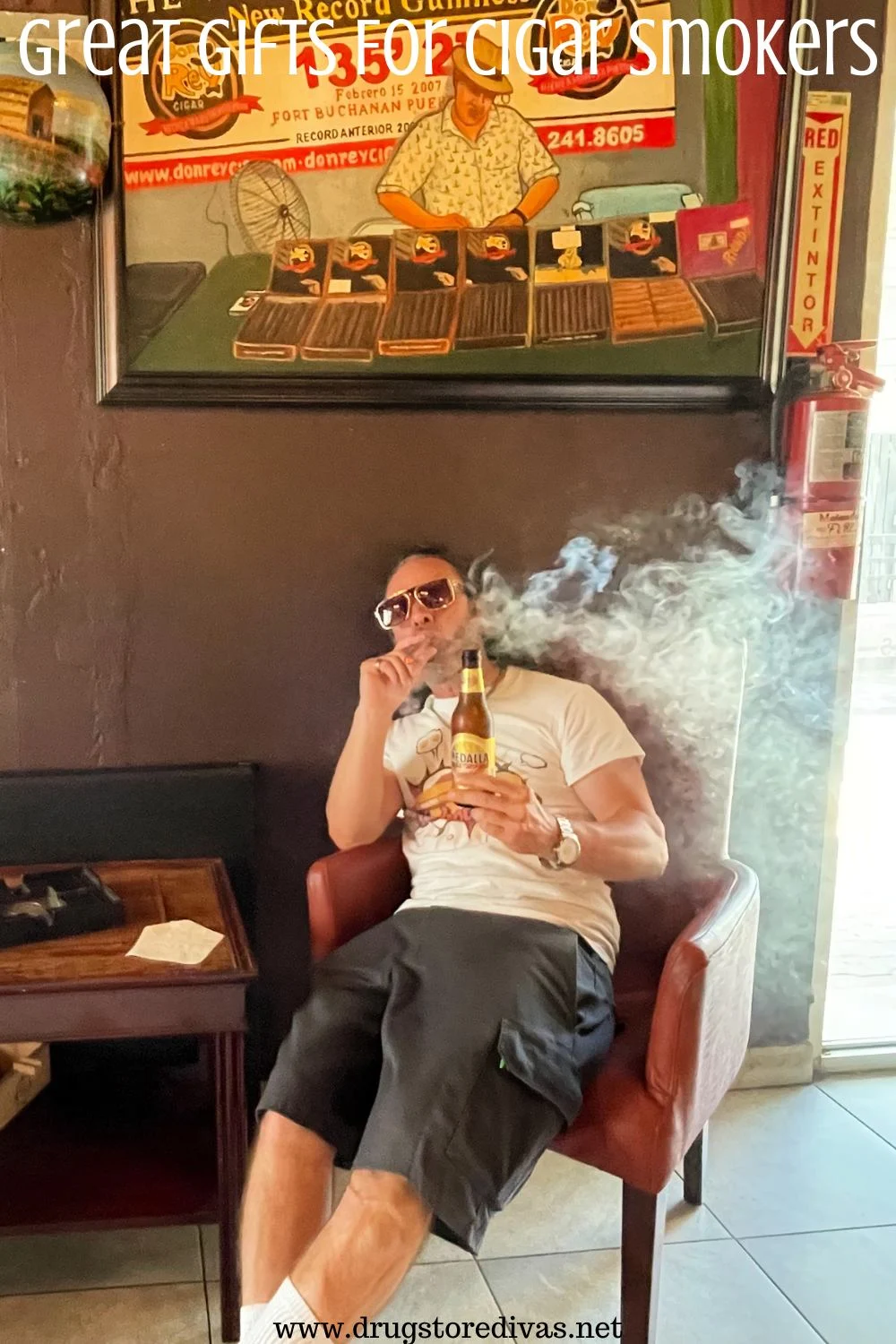 A man in a cigar lounge, holding a beer and smoking a cigar, with the words 
