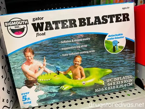 An alligator water blaster pool ship in a box on a shelf in a store.