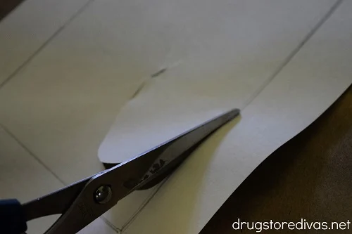 A frame template being cut with scissors.