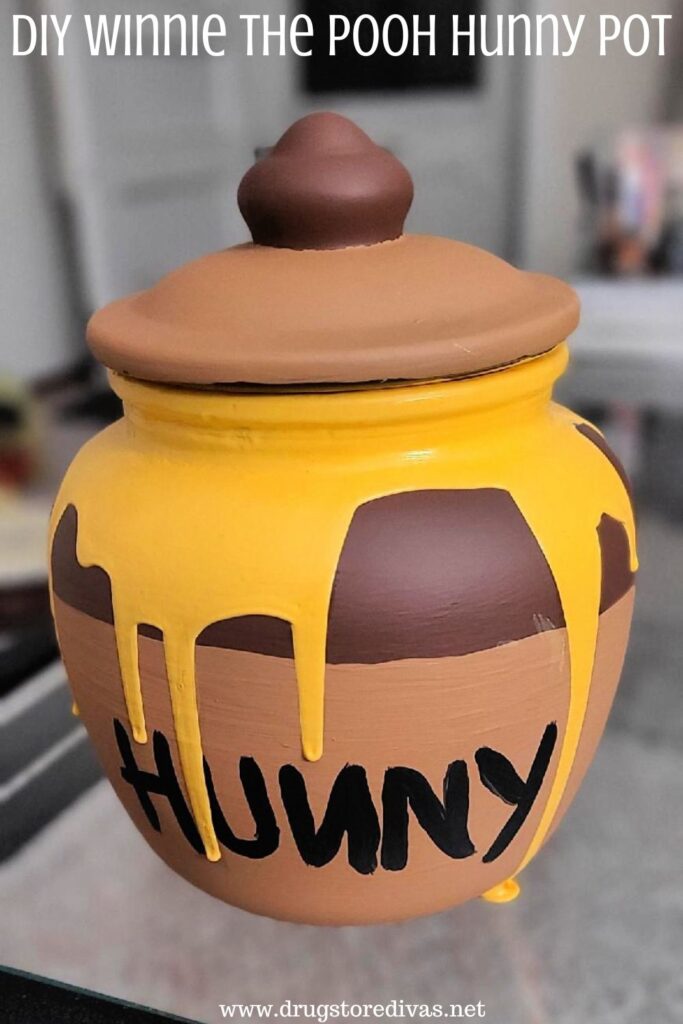 A homemade Winnie the Pooh honey pot replica with the words "DIY Winnie The Pooh Hunny Pot" digitally written on top.