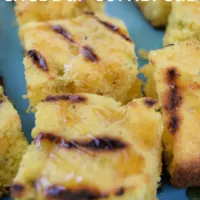 Pieces of cornbread on a plate with the words 