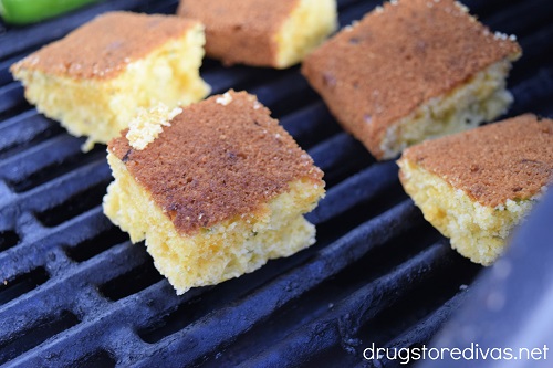 Slices of cornbread on a grill.