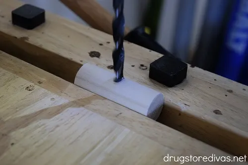 A wooden dowel being drilled.