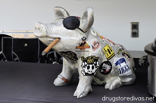 A ceramic pig decorated with stickers.