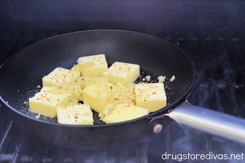 Garlic butter ingredients in a pan on the grill.