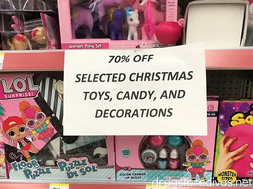 A sign on a shelf at Walgreens advertising 70% off selected Christmas toys, candy, and decorations.