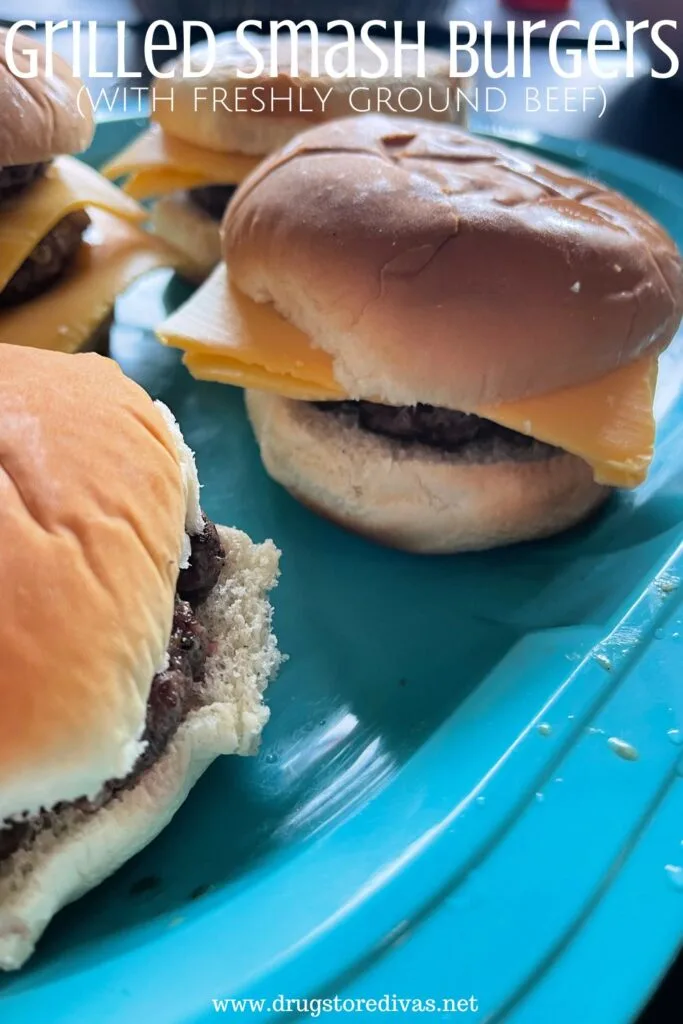 Four burgers on a plate with the words "Grilled Smash Burgers (with freshly ground beef)" digitally written on top.